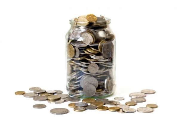 Overflowing jar of Australian coins