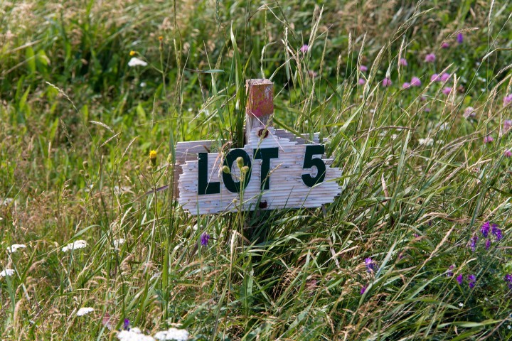 Vacant block with lot number sign.